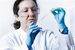 Scientist dropping liquid into petri dish