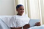 Female hospital patient using digital tablet