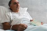 Male hospital patient with get well soon card