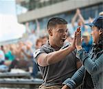 Couple high-fiving at sports game