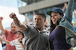 Couple cheering at sports game