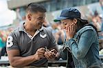 Man proposing to girlfriend at sports game