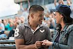 Couple getting engaged at sports game