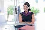 Smiling businesswoman sitting at desk