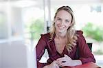 Smiling businesswoman sitting at desk