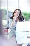 Businesswoman talking at desk