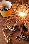 Sparkler, doughnut and cup of coffee