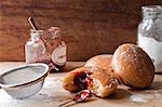 Doughnuts, jam and sugar on table