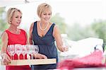 Women setting table outdoors