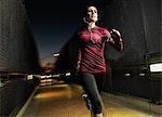 Woman running on pedestrian bridge