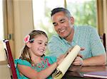 Father helping daughter with homework