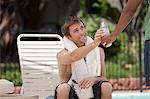 Man having water in swimming pool