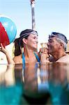 Couple swimming together in pool