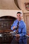 Businessman with newspaper at breakfast