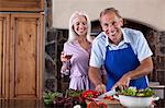 Older couple cooking in kitchen