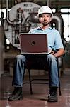 Industrial worker using laptop