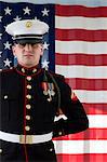 Serviceman in dress blues by US flag