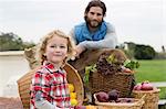 Father and son with produce in truck bed