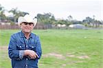 Farmer smiling in grassy field