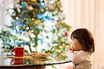 Girl eating Christmas cookies