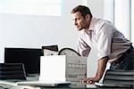 Businessman packing up box in office