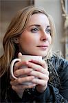 Woman having cup of coffee in cafe