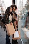 Women window shopping on city street