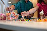 Children choosing toppings in store