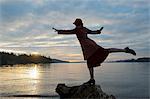 Woman balancing on rock formation