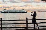 Woman taking picture of cruise ship