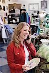 Woman on cell phone in thrift store