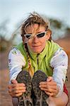 Runner stretching on dirt road