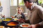 Father and daughter eating together at table