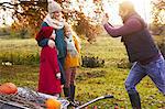 Father taking picture of family outdoors