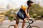 Man riding bicycle on city street