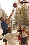 Men playing basketball on court