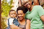 Smiling family standing outdoors