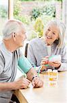Older woman testing husband's blood pressure