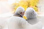 Older couple standing together in park