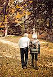 Older couple walking together in park