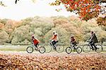 Family riding bicycles together in park