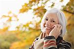 Older woman talking on cell phone in park