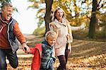 Boy and grandparents walking in park