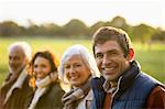 Family smiling together in park