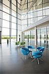 Chairs and table in office lobby area