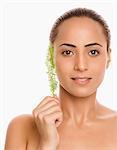 Portrait of a woman holding herb