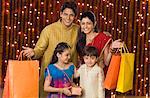 Portrait of a family with shopping bags and Diwali gift