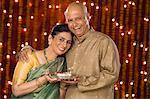 Couple holding pooja thali