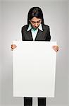 Businesswoman holding a placard