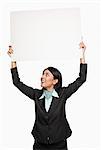 Businesswoman holding a placard over her head